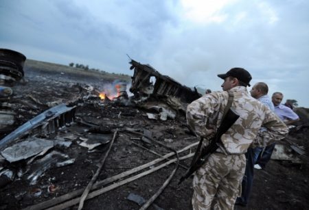 © Getty Images - People stand next to the wreckages of the Malaysian Airliner carrying 295 people from Amsterdam to Kuala Lumpur after it crashed, near the town of Shaktarsk, in rebel-held East Ukraine, on 17 July 2014 (Getty Images)
