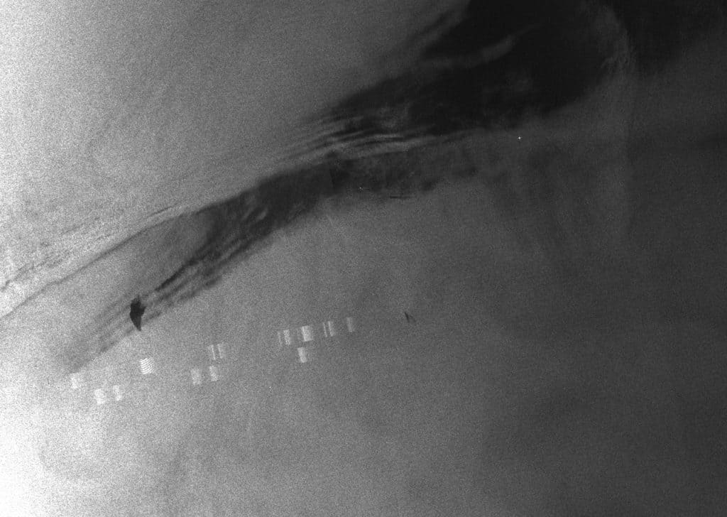Envisat-1 data – 1 - Envisat-1 data reveals characteristics present on the surface of the sea - different degrees of sea roughness and currents, returns indicating the presence of ships. The two bands are caused by a sensor-related error. (Forensic Oceanography)