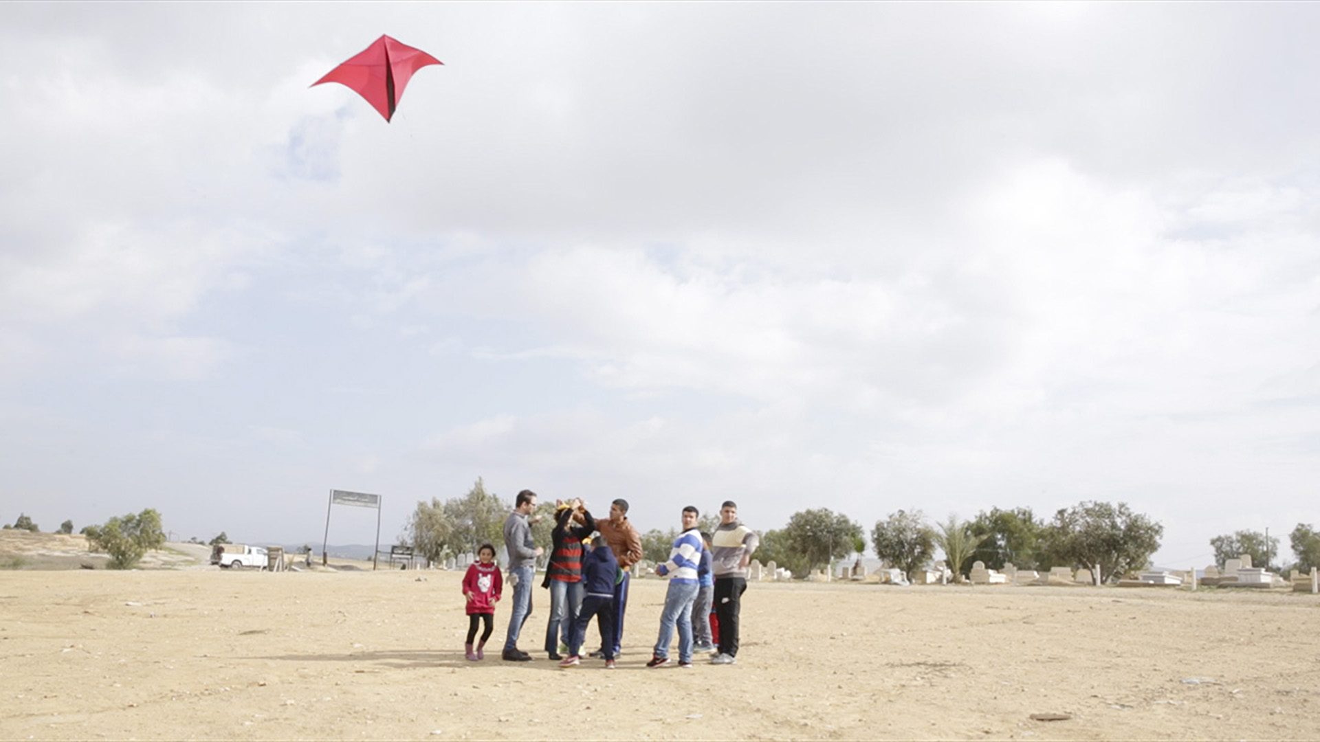 Community Satellites – 2 - Ariel Caine, Hagit Keysar, and the children of Araqib fly kites mounted with cameras on the edge of the al­-Turi Cemetery, January 2016. (Forensic Architecture)