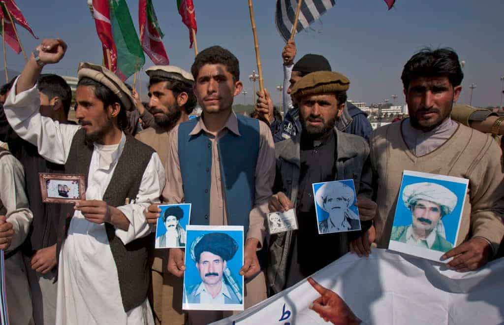 Protestors in Datta Khel - Protesters in Datta Khel holding pictures of the victims of the strike. (Anjum Naveed/AP)