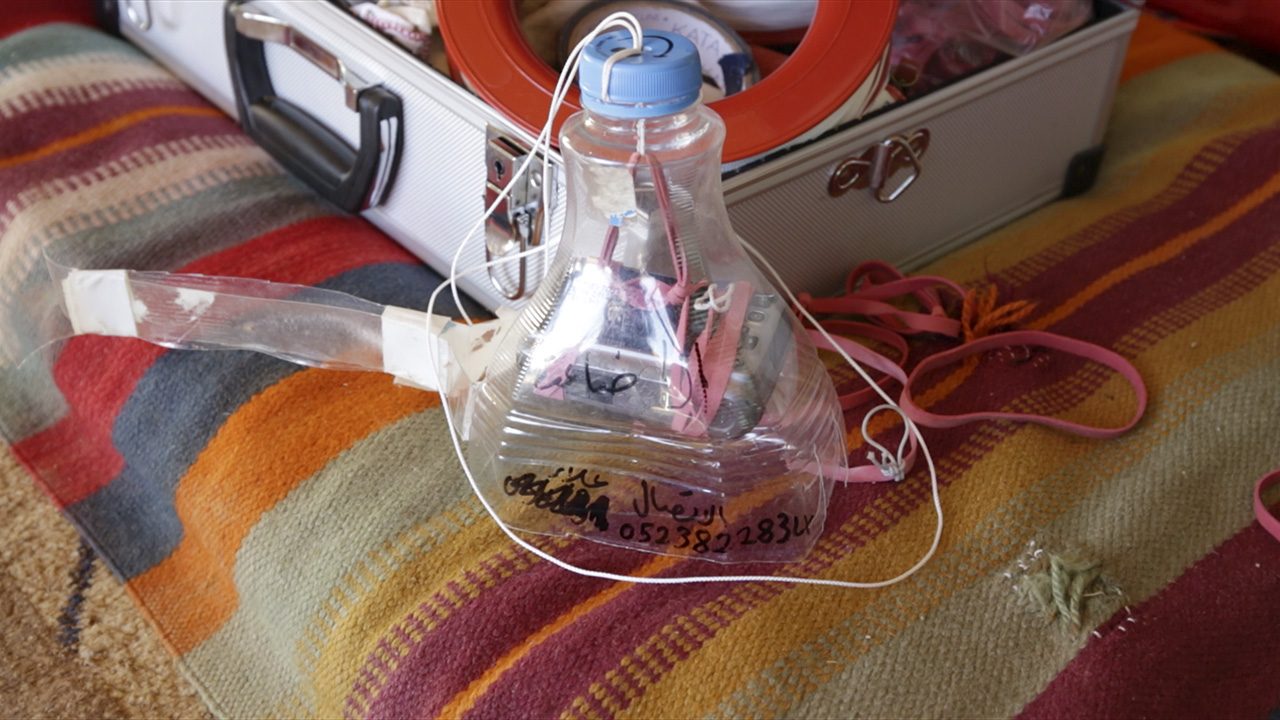 Community Satellite – 1 - A kite, camera and plastic bottle 'rig', known as a 'community satellite'. (Hagit Keysar and Forensic Architecture, 2016)