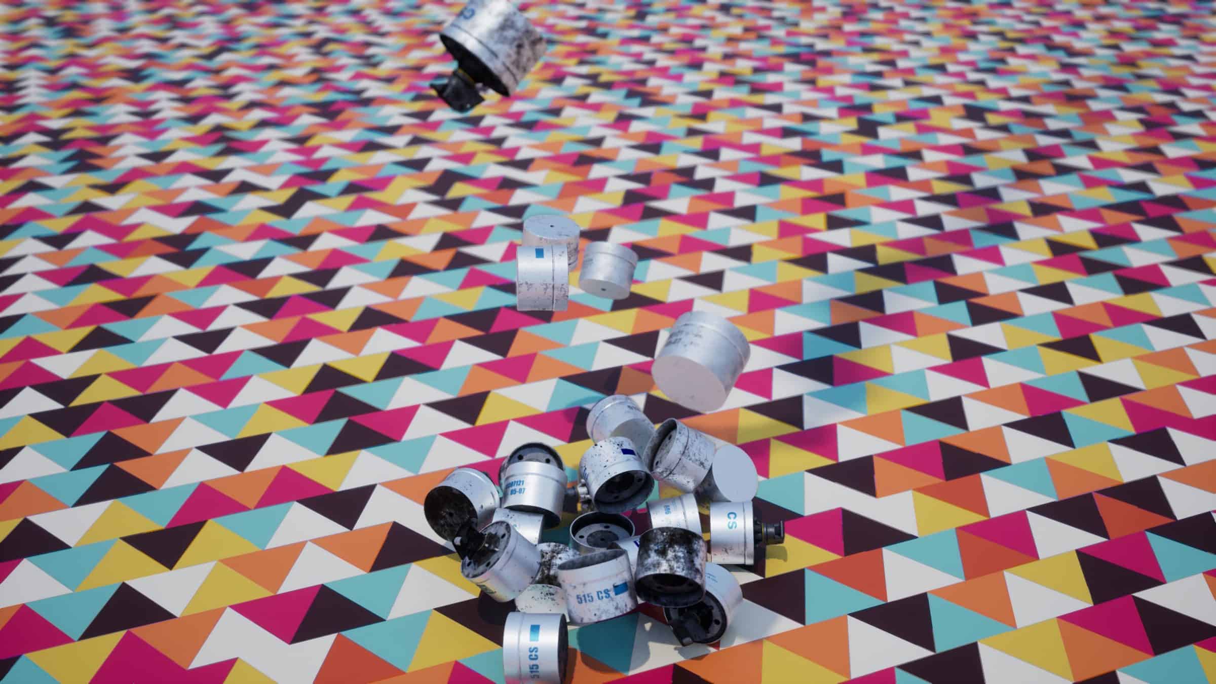 Decontextualised – 1 - Producing images of our model against bold, generic patterns improves the classifier's ability to identify the grenade. (Forensic Architecture)