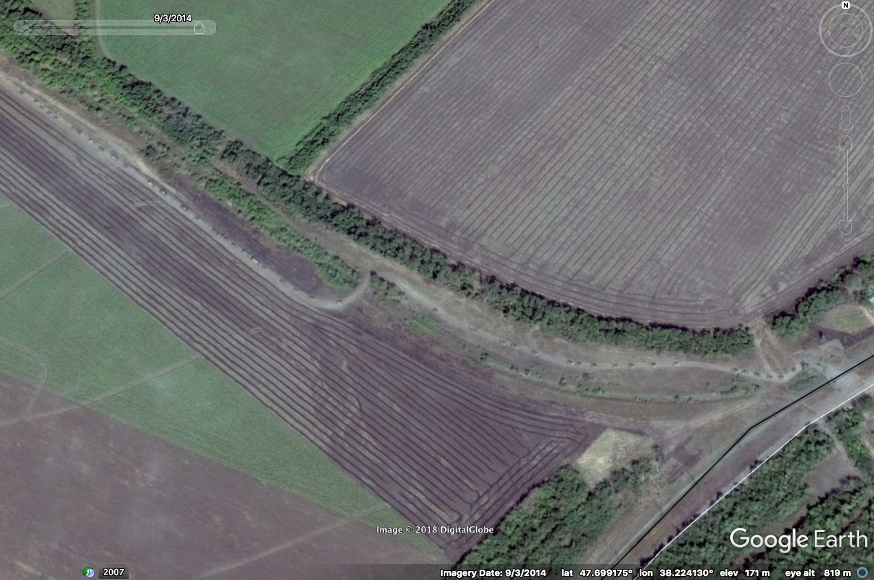 Satellite imagery – 1 - A convoy of vehicles is visible on a Ukrainian road, approaching the border with Russia, on 3 Sep 2014⁠—immediately following the defeat of the Ukrainian Armed Forces. (Google Earth)