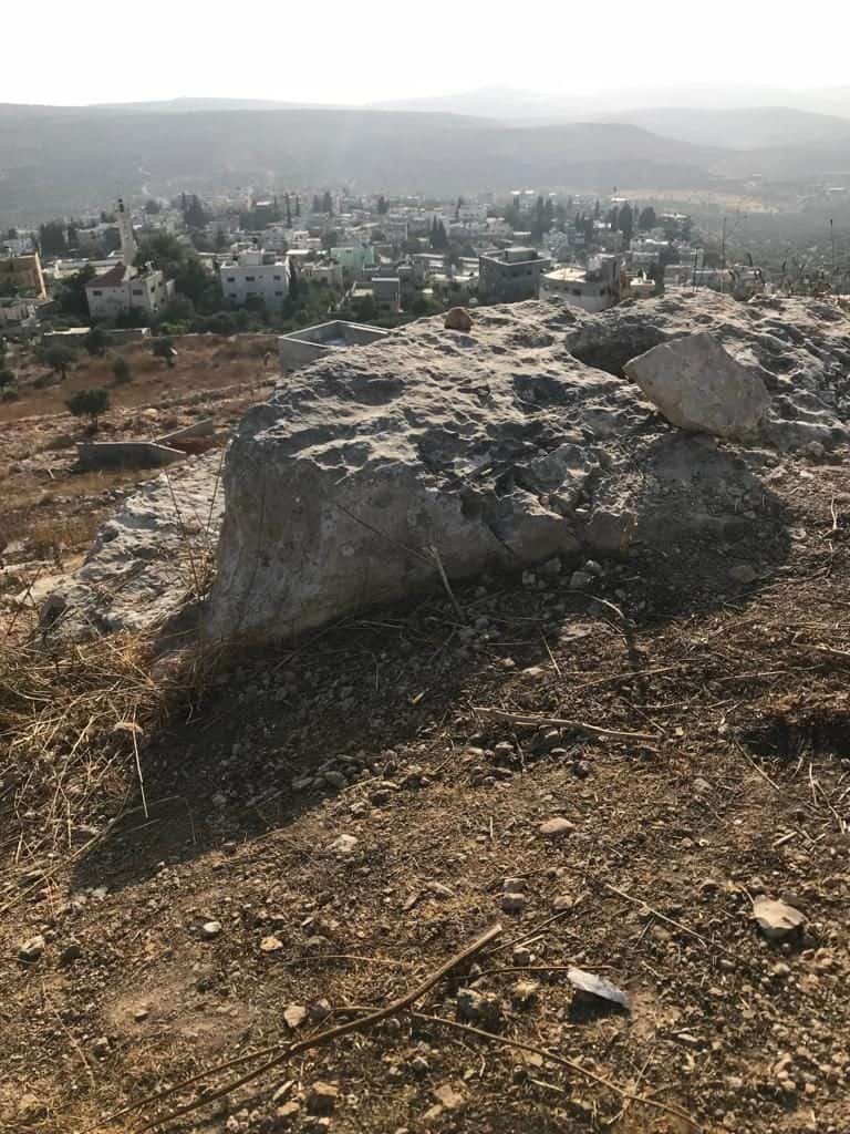 Casing – 2 - Multiple casings for 5.56mm ammunition rounds are visible on the ground, with the village of Kafr Qaddum in the near distance. (Supplied)