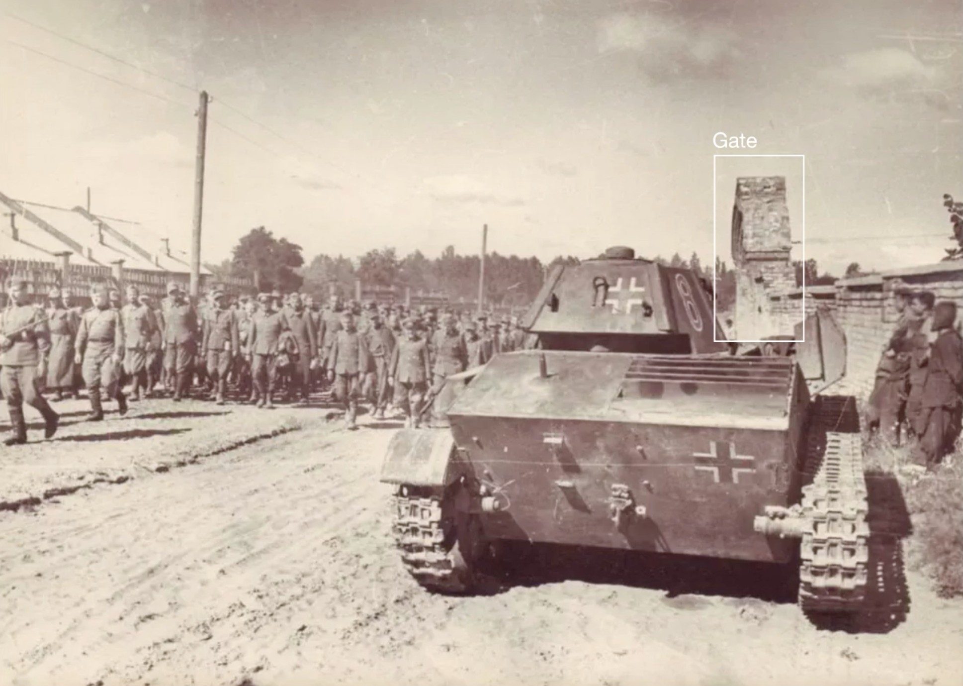 Soviet troops with German captives - Fig. XI. Soviet troops on Illienka Street lead German prisoners of war on 16 August 1944. The same gate (outlined here) is also visible in in CCTV footage of the TV tower strike, allowing FA and the CST to place it within the Babyn Yar site. Original source unknown.