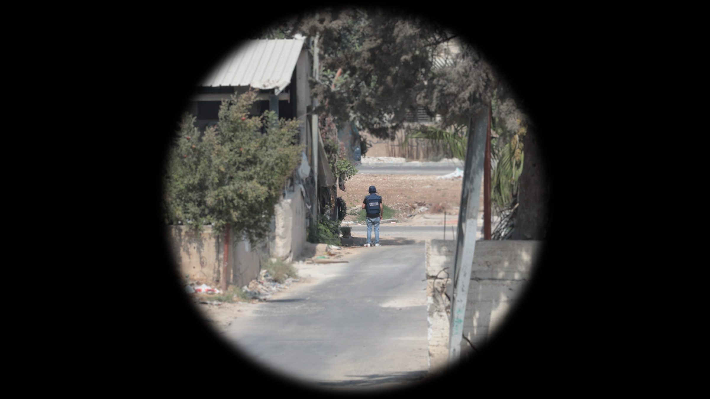 Ali-Position_Cropped - Optical reconstruction of the visibility of Ali’s vest in the moment he was shot, as seen from the location of the marksman. Telephoto magnification mimics the effect of the optical scope the marksman most likely used (Trijicon COG x4).(Forensic Architecture and Al-Haq, 2022)