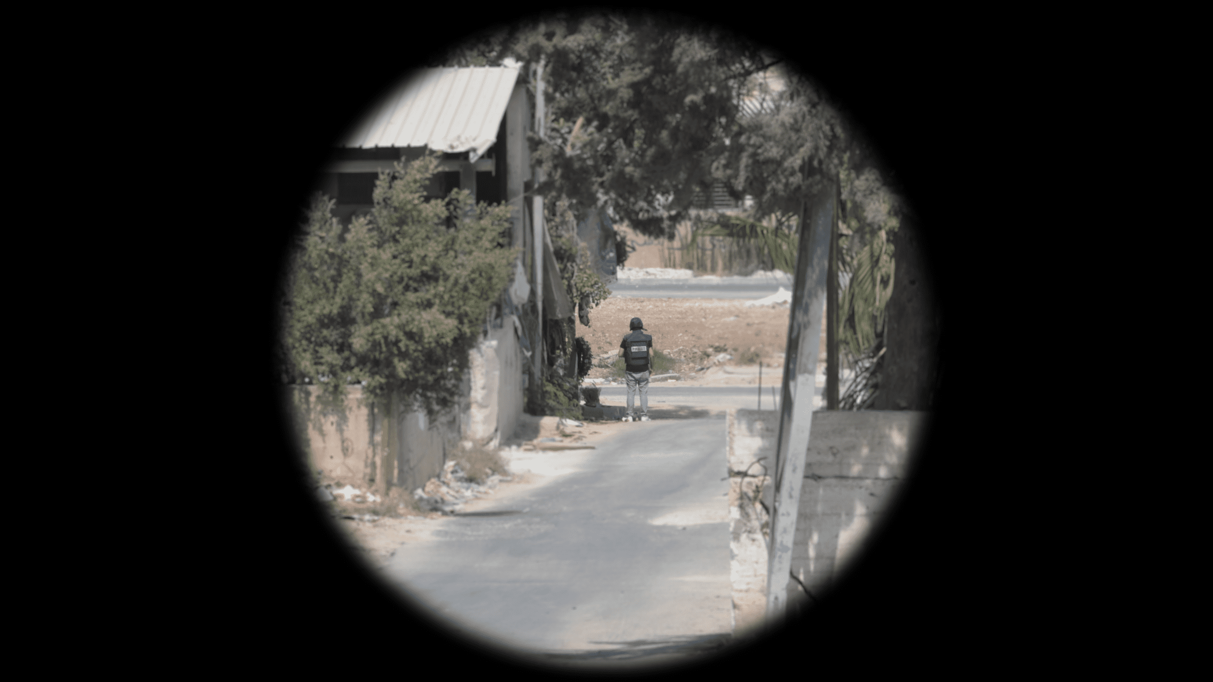 Ali-Position_Cropped - Optical reconstruction of the visibility of Ali’s vest in the moment he was shot, as seen from the location of the marksman. Telephoto magnification mimics the effect of the optical scope the marksman most likely used (Trijicon COG x4).(Forensic Architecture and Al-Haq, 2022)