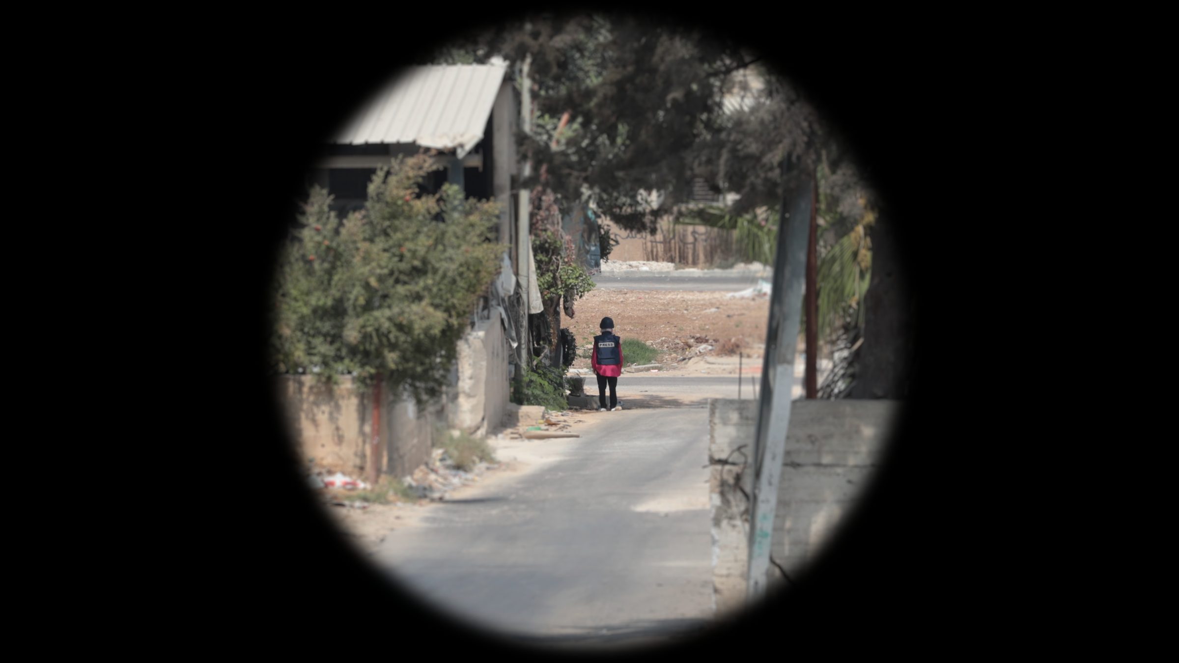 Shireen-Position_Cropped - Optical reconstruction of the visibility of Shireen’s vest at the moment she was shot, as seen from the location of the marksman. Telephoto magnification mimics the effect of the optical scope they most likely used (Trijicon COG x4). (Forensic Architecture and Al-Haq, 2022)