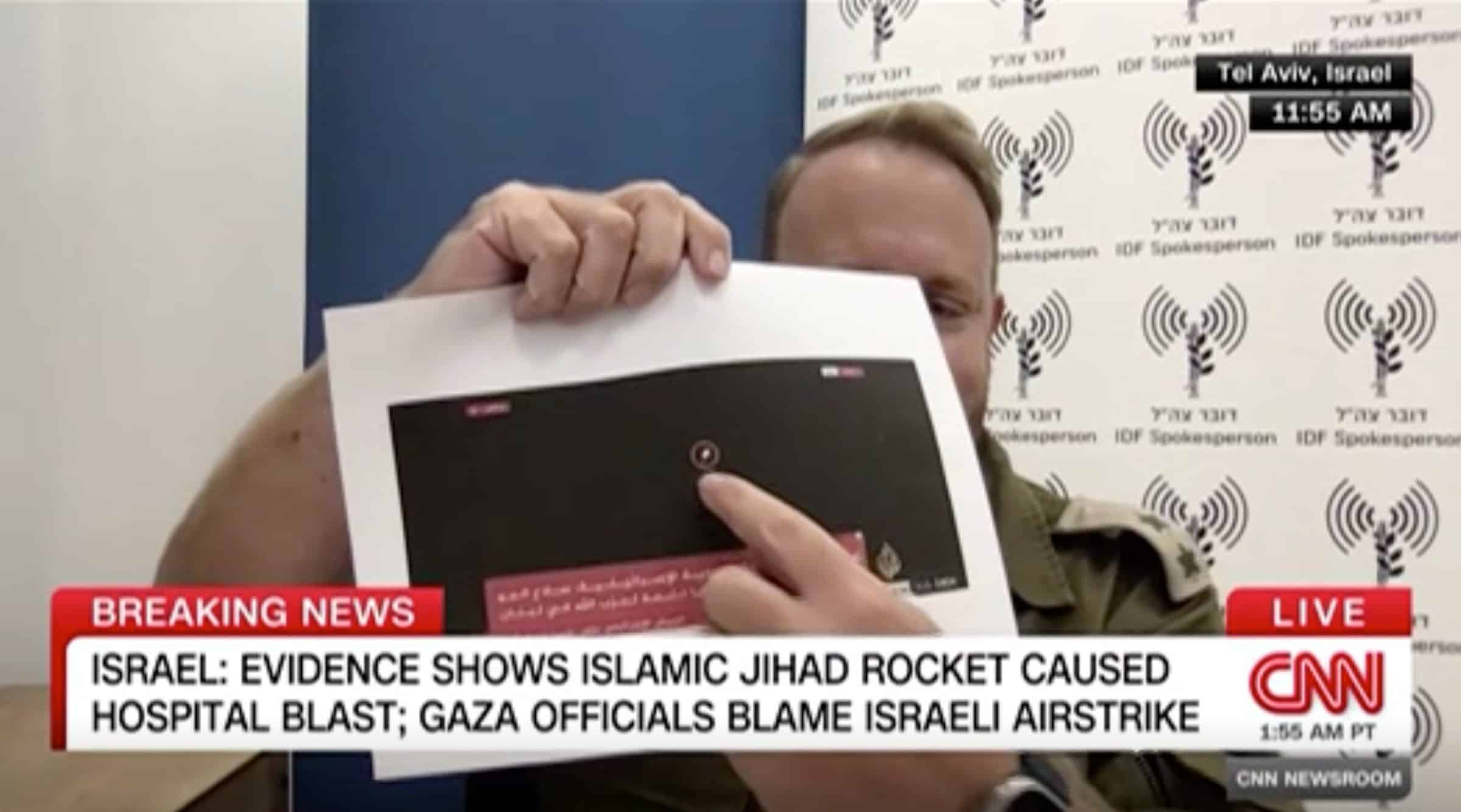  - Lt. Col. Peter Lerner on CNN holding a printed frame from an Al-Jazeera Livestream, 18 October 2023.