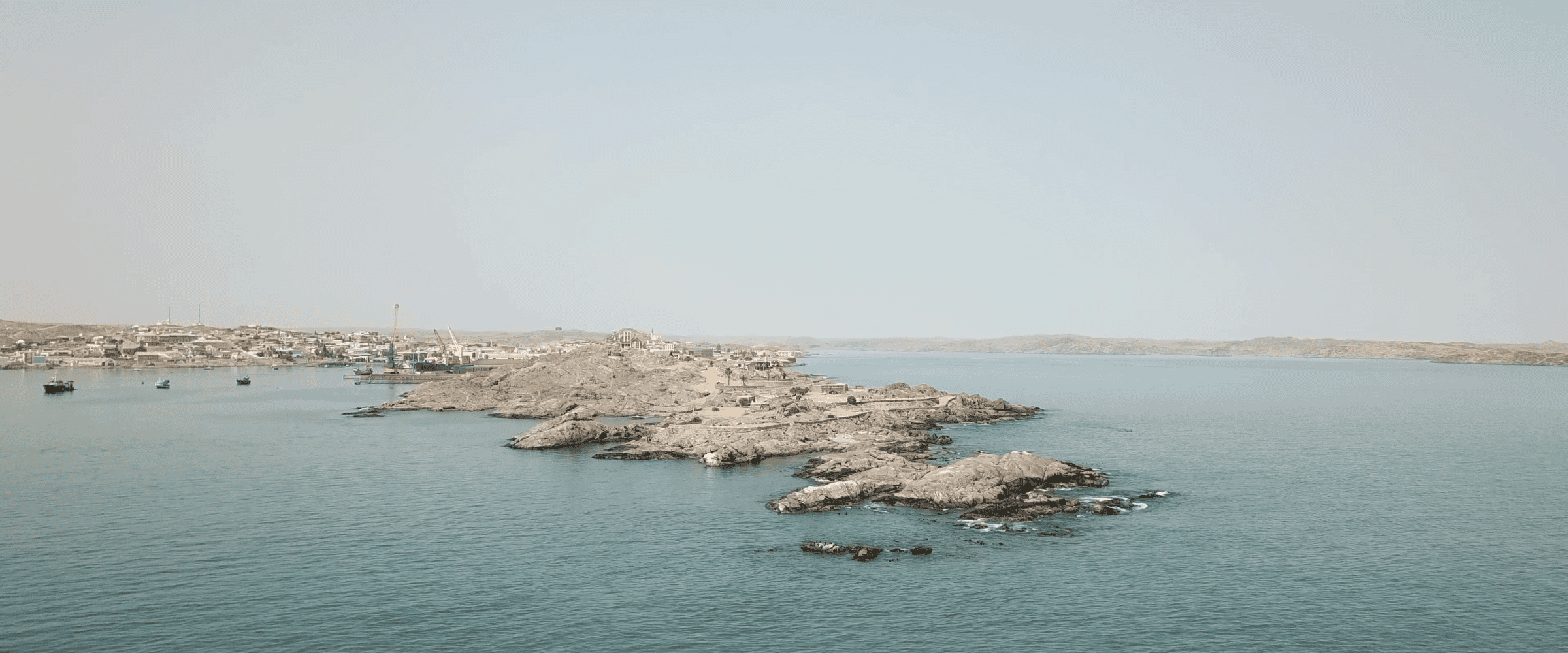 Drone Photograph of Shark Island - Drone photograph of Shark Island seen from northeast. Authorities are planning an expansion of the port, threatening the preservation of Shark Island as a site of contemplation. (Forensic Architecture/Forensis, 2024)