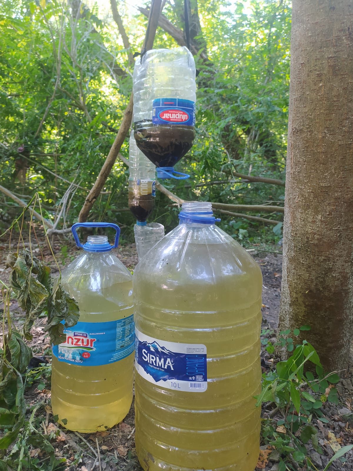DIY Filtering System - A diy system used by a stranded group to filter the river waters. The group was left without drinking water and resorted to drinking from the muddy and polluted river. (AlarmPhone, 2021)